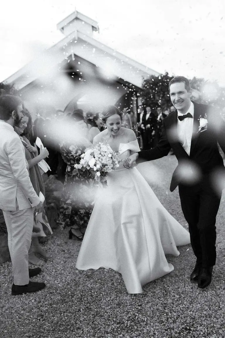 Newlyweds celebrating as confetti falls