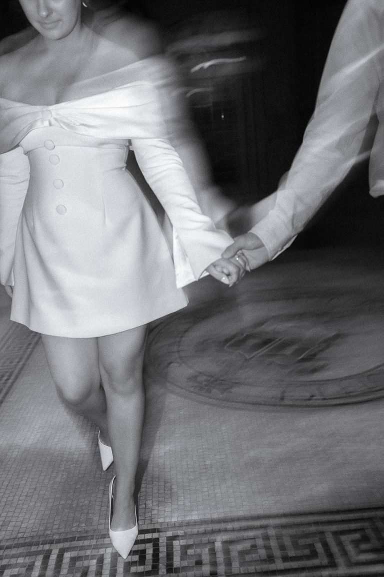 A close, candid moment holding hands